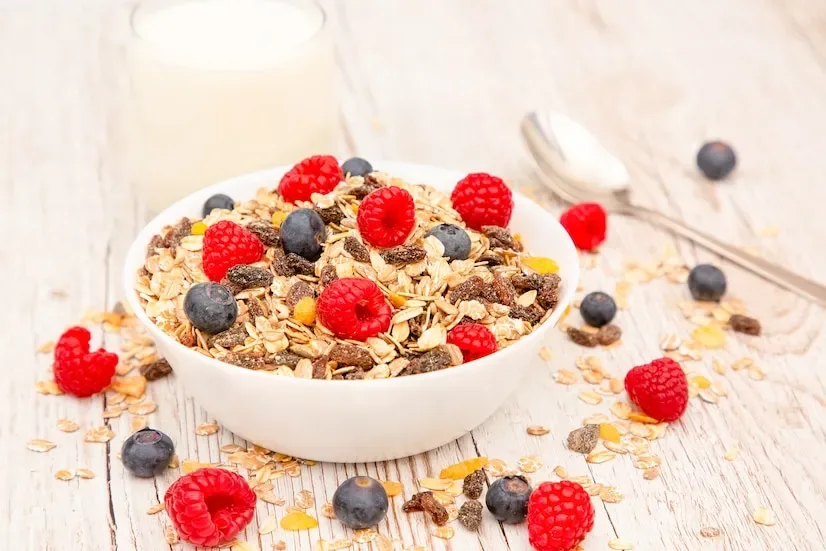How does granola help in managing weight due to its nutrient density and fiber?